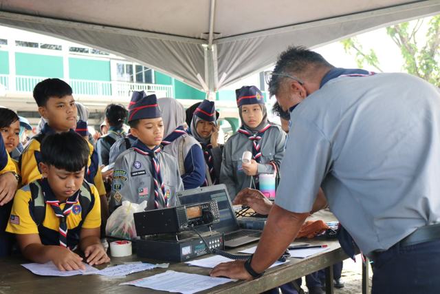 HF station — logging contacts with young operators